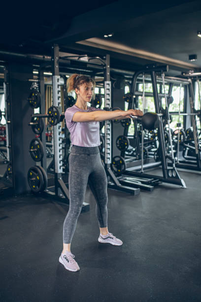 istock Young woman training in gym with kettlebell 1488825192