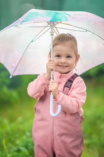 Beautiful girl in the rain with umbrella