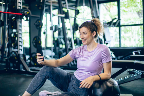 istock Young female athlete using smartphone in the gym 1488825617