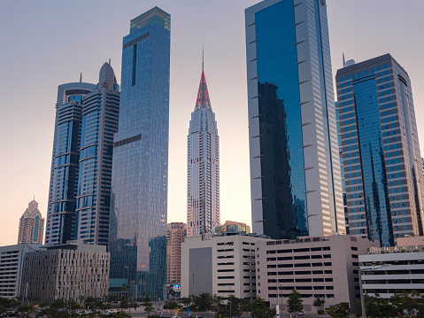 25 March 2023, Dubai, UAE: expensive luxury skyscrapers in the area Emirates Towers Metro Station, tourist trip to futuristic dubai