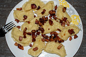 Homemade dumplings with bacon and pork fat