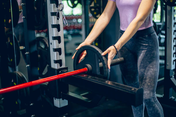 istock Young woman athlete preparing for weight lifting 1488827572