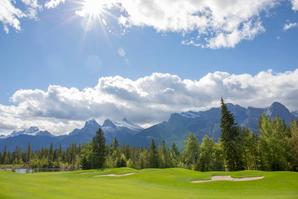 istock Scenic view of green golf course and mountains 1488829365