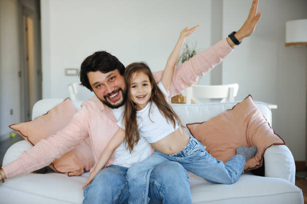 istock Happy single father having fun with his small daughter at home. 1488833341