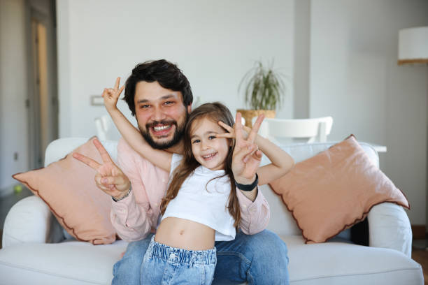 istock Happy single father having fun with his small daughter at home. 1488833511