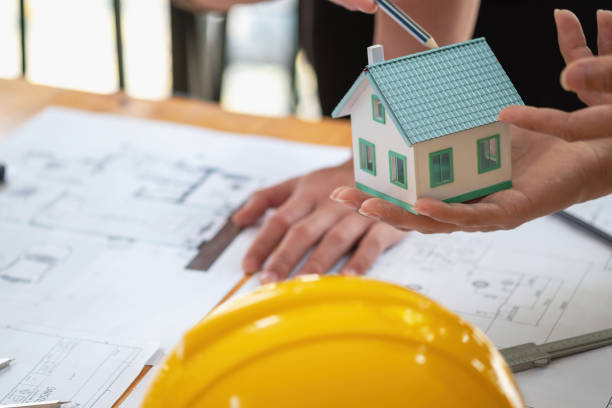 istock Asian engineers brainstorm and measure to document cost estimates and write floor plans for architectural and engineering designs for houses and buildings. 1488835732