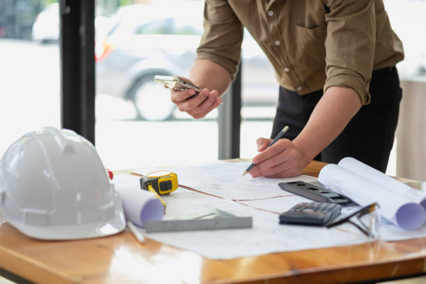 istock Asian engineers brainstorm and measure to document cost estimates and write floor plans for architectural and engineering designs for houses and buildings. 1488836221