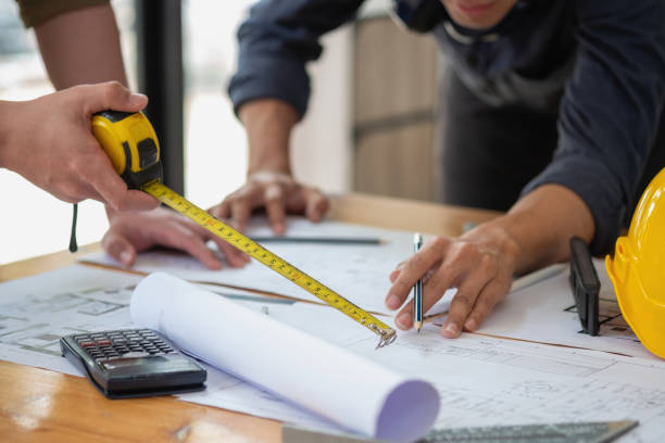 istock Asian engineers brainstorm and measure to document cost estimates and write floor plans for architectural and engineering designs for houses and buildings. 1488836239