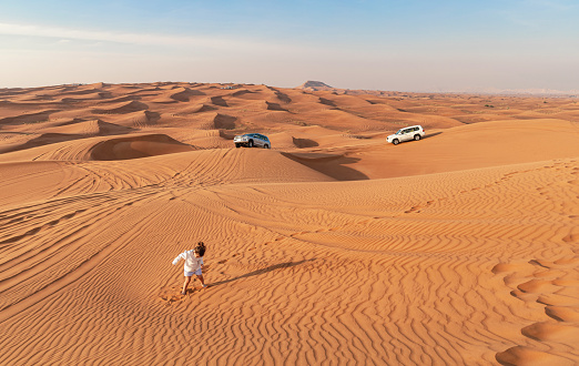 The Empty Quarter, or Rub al Khali - The world's largest sand deser in Dubai. Little girl in the desert. Dubai, UAE - April 30, 2023.