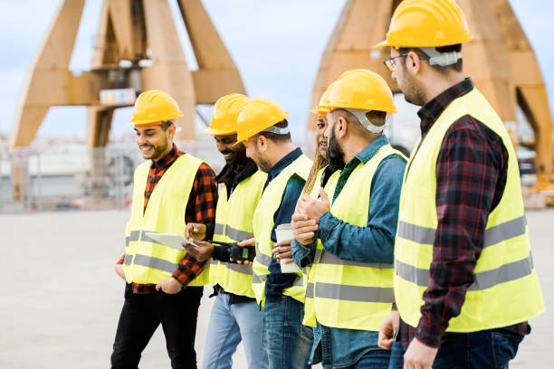 istock Group of engineer people working at cargo terminal at maritime port - Main focus on African woman face 1488837063