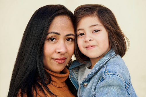 Happy Asian mother and daughter looking at camera - Family love concept