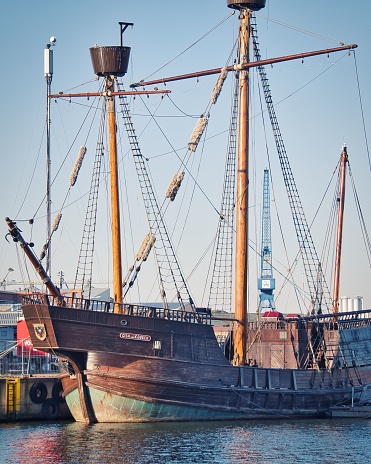 Luebeck, Germany – July 01, 2022: A large, wooden pirate ship is securely docked at a busy pier, surrounded by other vessels