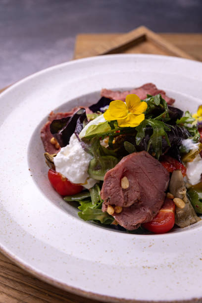 istock A salad with a piece of meat and cheese 1488839384