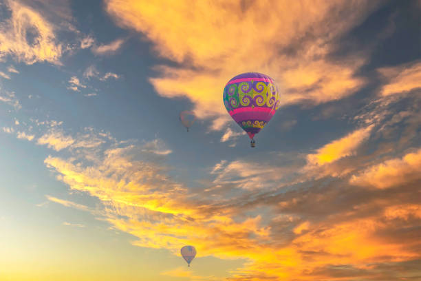 istock Balloons are flying in the sky against sunset light. 1488840501