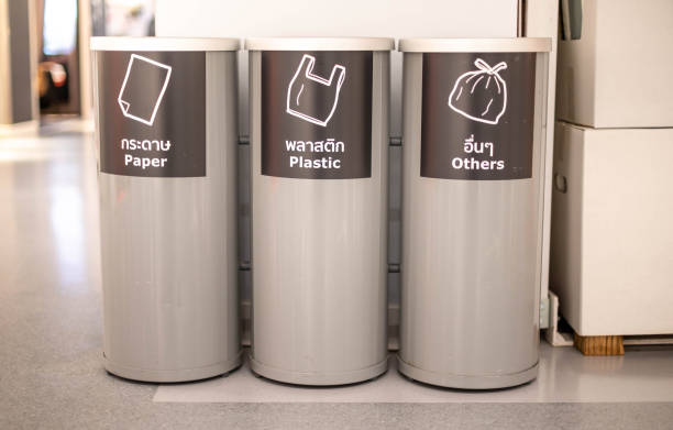 istock Modern metal cylinder trashcan or bin which separate the type of garbage put on at the public area, department store. 1488841030