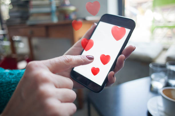 istock woman using smartphone with red hearts coming out 1488841204