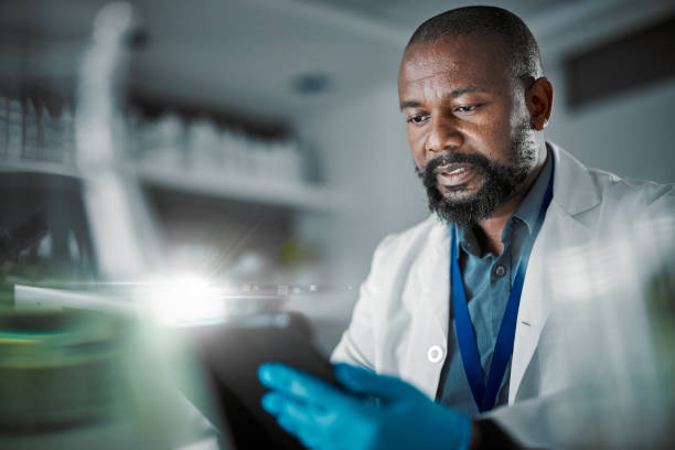 istock Black man, tablet or thinking in science laboratory for medical research, innovation or ideas for genetic engineering. Plant scientist, worker or biologist with technology for sustainability research 1488843304