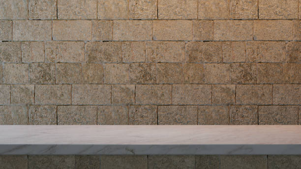 istock Marble countertop with top light and empty space. Old medieval brick wall and top side of the table. 1488844064