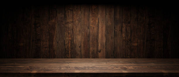 istock Old planks wall and table with light empty space. Vintage wooden background and spotlight showroom. 1488844067
