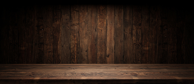 Old planks wall and table with light empty space. Vintage wooden background and spotlight showroom.