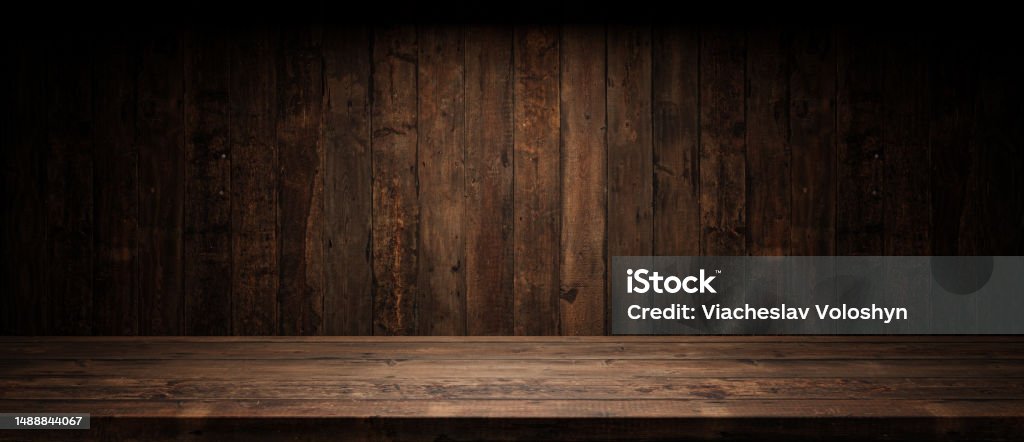 Old planks wall and table with light empty space. Vintage wooden background and spotlight showroom. Wood - Material Stock Photo