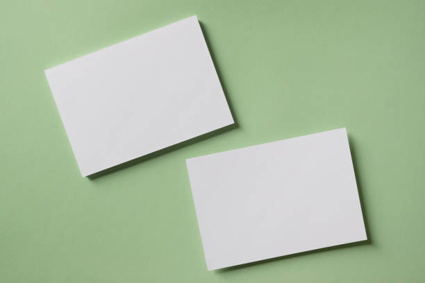 White blank greeting or invitation card mockup on green background. Mock up presentation.
