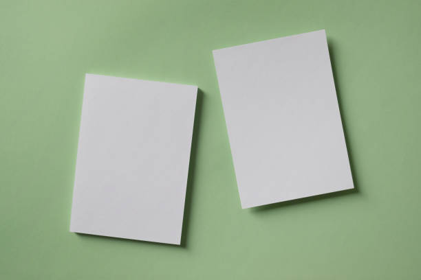 istock White blank greeting or invitation card mockup on green background. Mock up presentation. 1488845321
