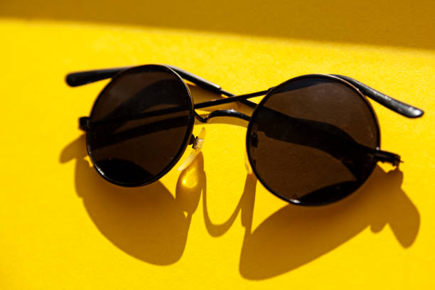 istock sunglasses lying in the sun on yellow surface, seventy model 1488846483