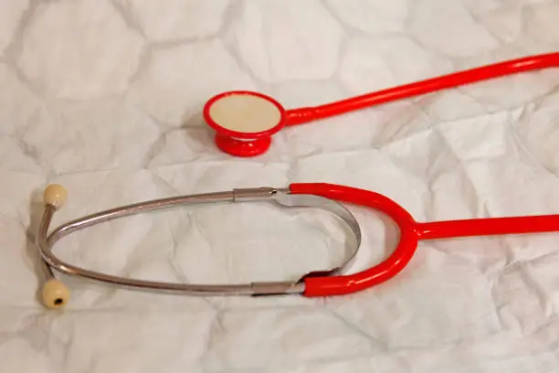 a doctor's stethoscope is lying on a hospital bed