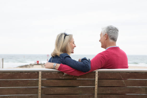 istock Mature couple on a bench at the seaside 1488847618