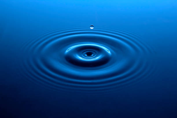 istock Water drop in a blue pool of water. 1488848272