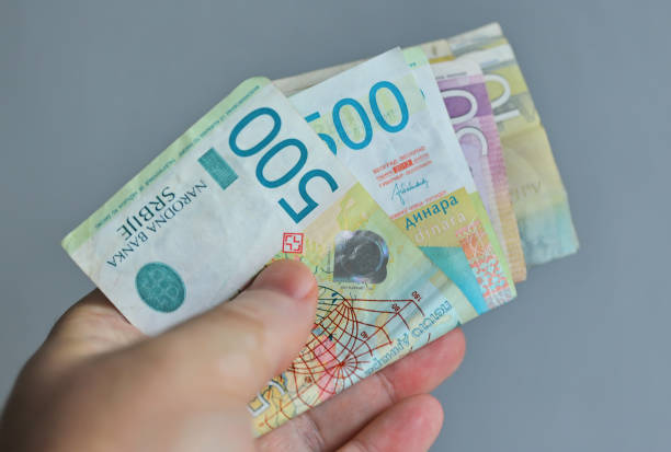 istock Hand holding cash money isolated on gray 1488850130