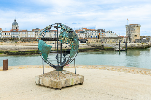 Globe of La Francophonie, a bronze sculpture by Bruce Krebs on Saint Jean d'Acre Square in the Old Port of La Rochelle, France