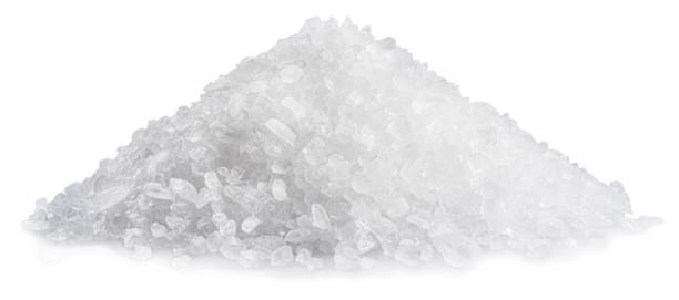 istock Pile of salt crystals close up, isolated on white background. 1488853364