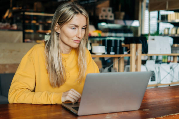 istock Caucasian woman working on a laptop in a cafe 1488853383