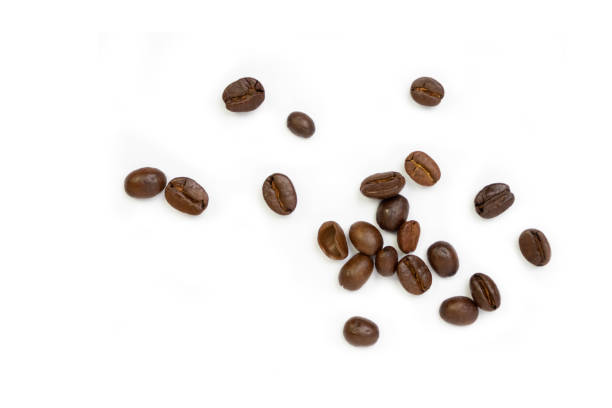 istock Roasted coffee beans pile from top on white background, Coffee beans. Isolated on a white background. 1488853447