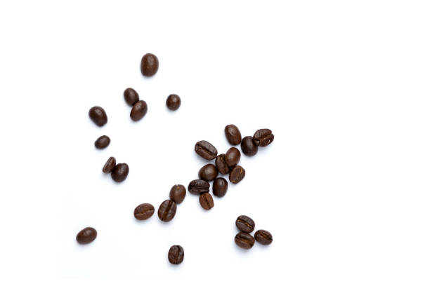 istock Roasted coffee beans pile from top on white background, Coffee beans. Isolated on a white background. 1488853481