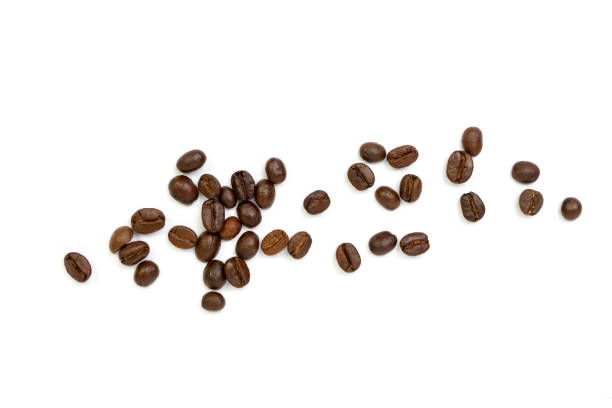 istock Roasted coffee beans pile from top on white background, Coffee beans. Isolated on a white background. 1488853486