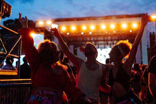 istock Three friends dance at open air festival. 1488854582