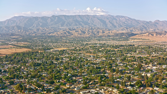 Aerial view of neighbourhood houses against mountain range, Beaumont, California, USA.