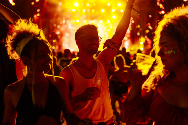 istock Young adults dancing at open air festival. 1488857156