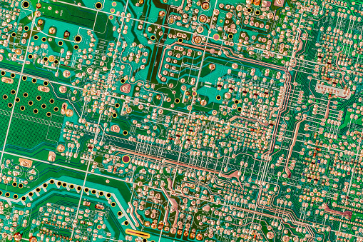 Photograph of vintage green PCB – electronic Printed Circuit Board detail, viewed directly above.