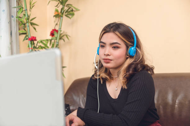 istock An attractive vlogger waiting for viewers on her channel. She put on some makeup and wore a blue headset. 1488861349
