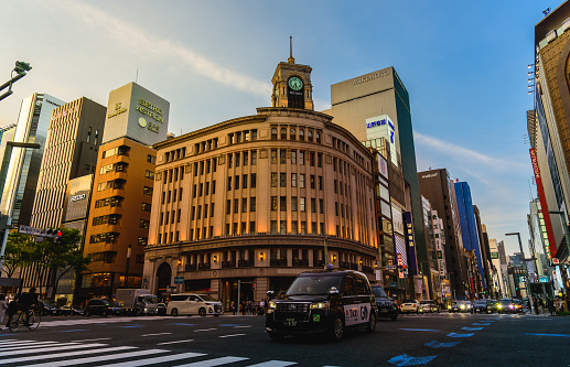 Tokyo, Japan - March 30, 2023 - Ginza district is the most famous upmarket shopping in Tokyo. Ginza at sunset with Ginza wako building in background.