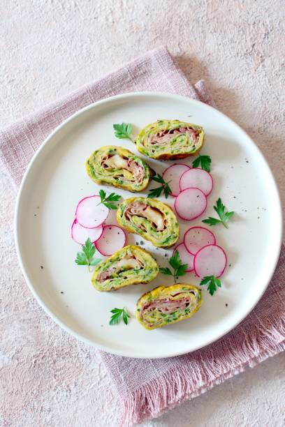 istock Omelette rolls with zucchini, ham and cheese. 1488863294