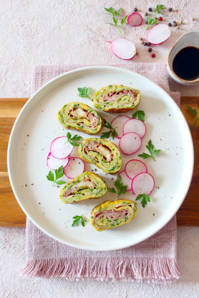 istock Omelette rolls with zucchini, ham and cheese. 1488863312