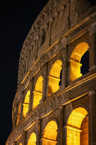 The iconic Coliseum of Rome, Italy illuminated by the lights at night