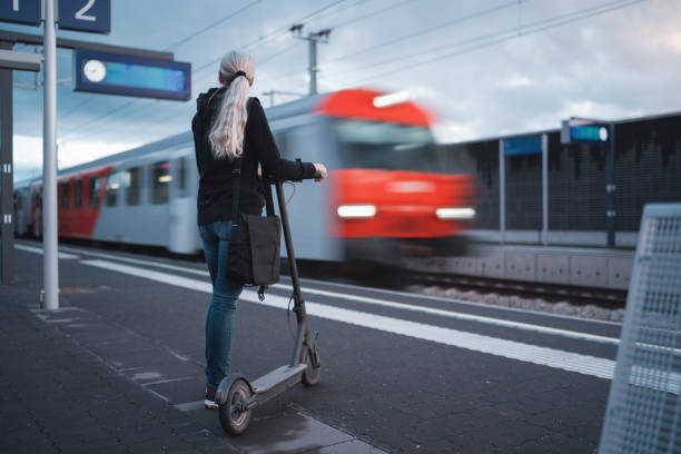 istock Woman waiting at railroad station platform for arriving train, back view 1488868247