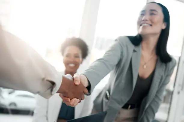 Photo of Healthcare, onboarding and handshake, doctors at job interview, meeting with HR recruitment agent. Diversity, human resources and hiring, asian woman shaking hands with doctor in welcome or thank you