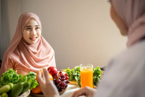 istock Asian Muslim nutritionist working advise a nutrition for patient using an Ipad showing data of body. 1488872222